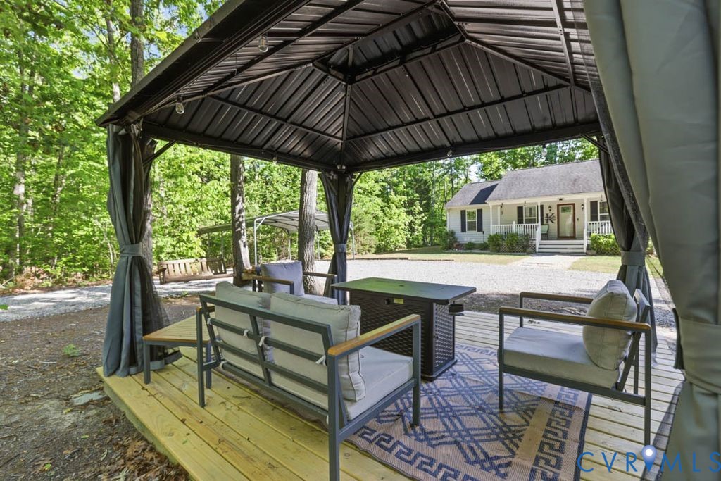 5307 St Pauls Church Road Goochland, VA 23063 - Photo 34 of 44 a view of patio with table and chairs under an umbrella