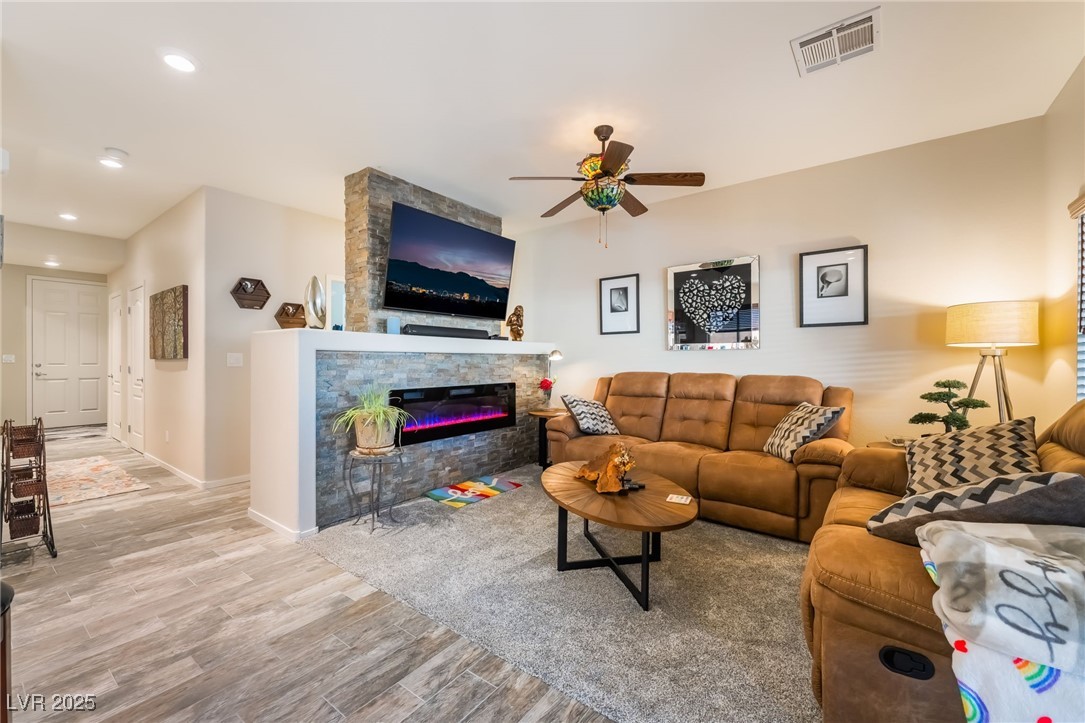 4732 Adriano Way Pahrump, NV 89061 - Photo 12 of 44 Living area with recessed lighting, wood finished floors, a ceiling fan, and a fireplace