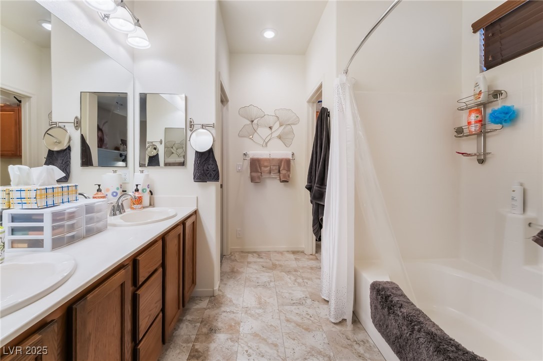 4732 Adriano Way Pahrump, NV 89061 - Photo 28 of 44 Full bath with double vanity and shower / bath combo with shower curtain
