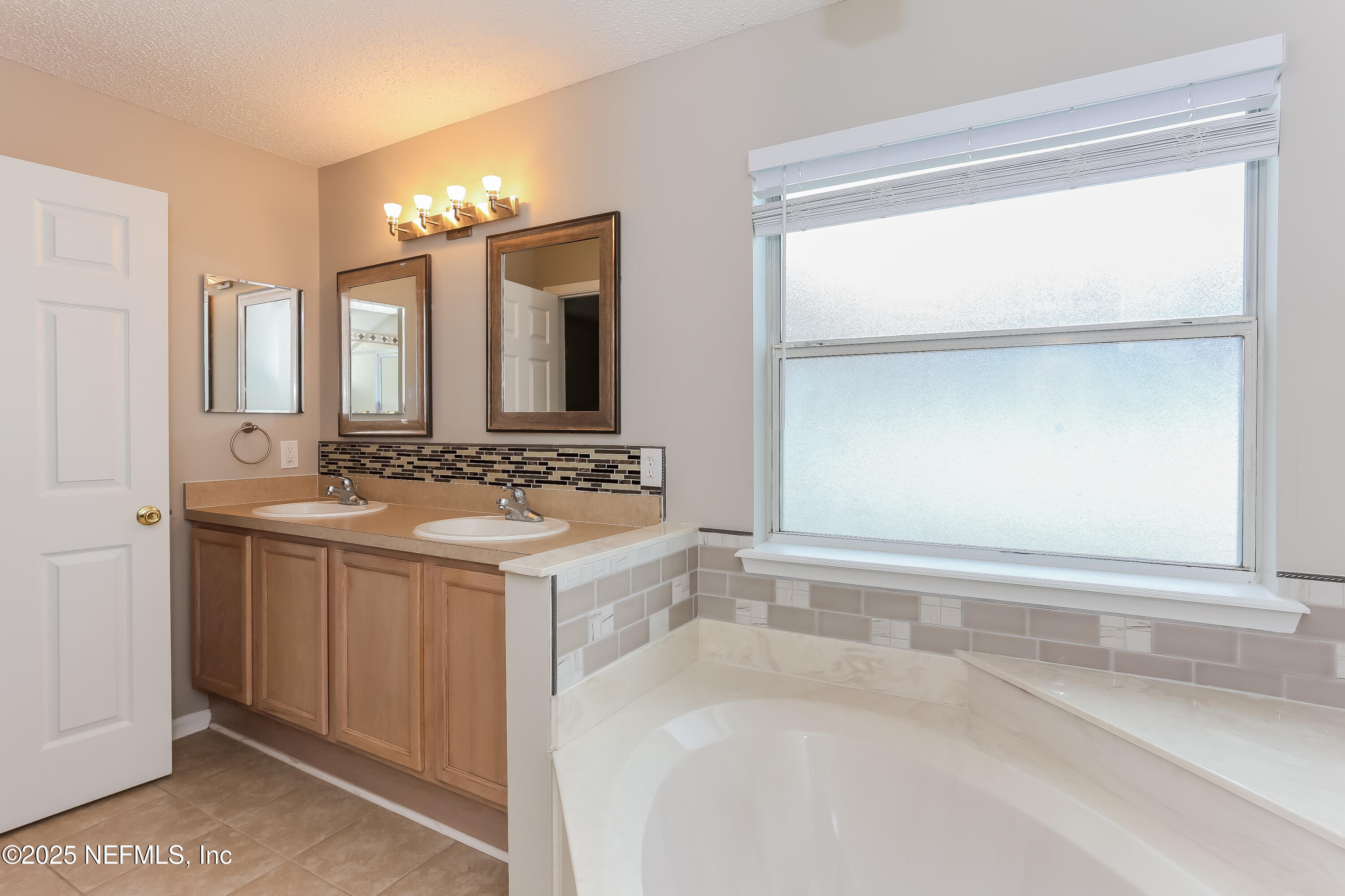 86293 Fieldstone Drive Yulee, FL 32097 - Photo 10 of 15 a bathroom with a sink and a mirror