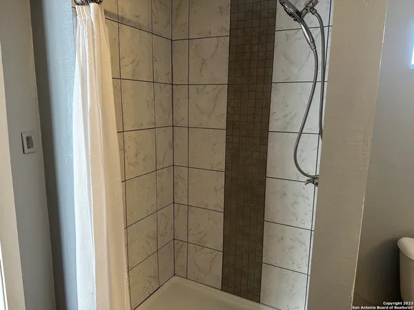 a bathroom with a glass shower door