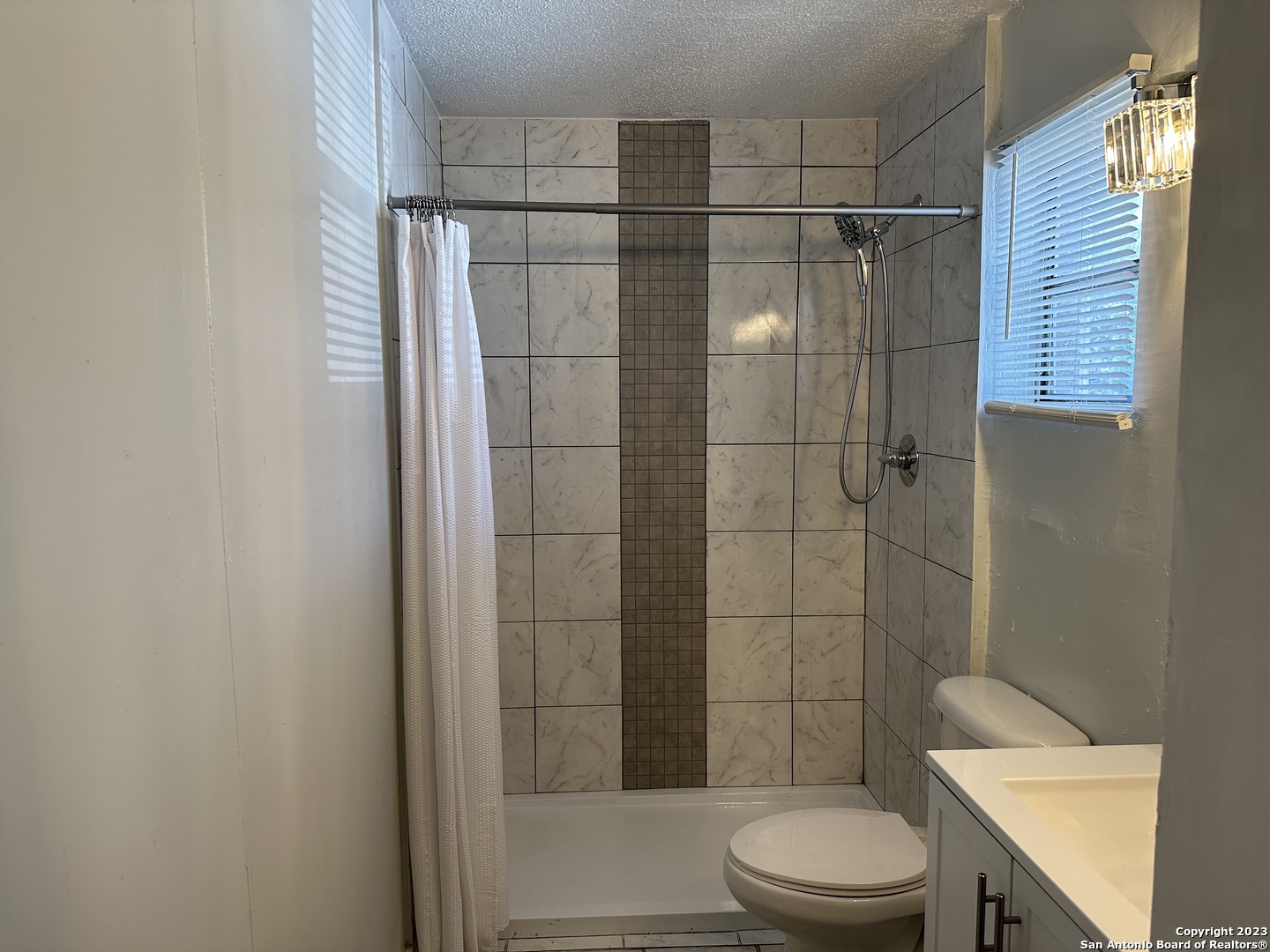 403.5 Retta Street Carrizo Springs, TX 78834 - Photo 17 of 17 a bathroom with a shower a toilet and sink