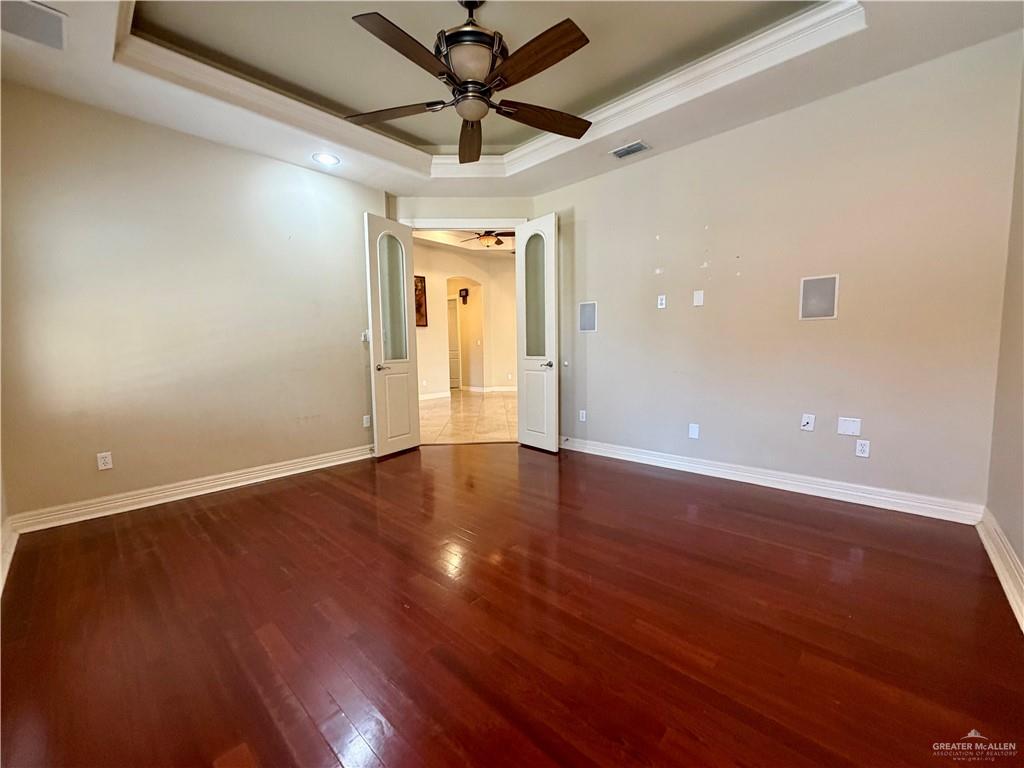 4101 Tyler Avenue McAllen, TX 78503 - Photo 6 of 12 an empty room with wooden floor and windows