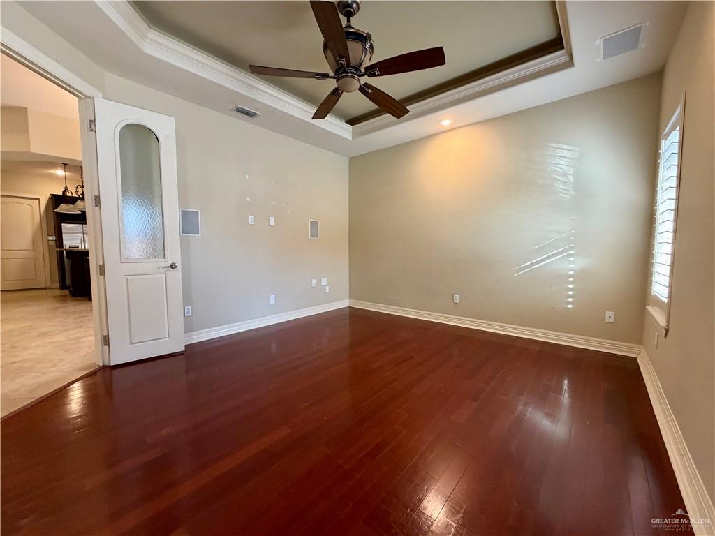 4101 Tyler Avenue McAllen, TX 78503 - Photo 7 of 12 a view of an empty room with wooden floor and a window
