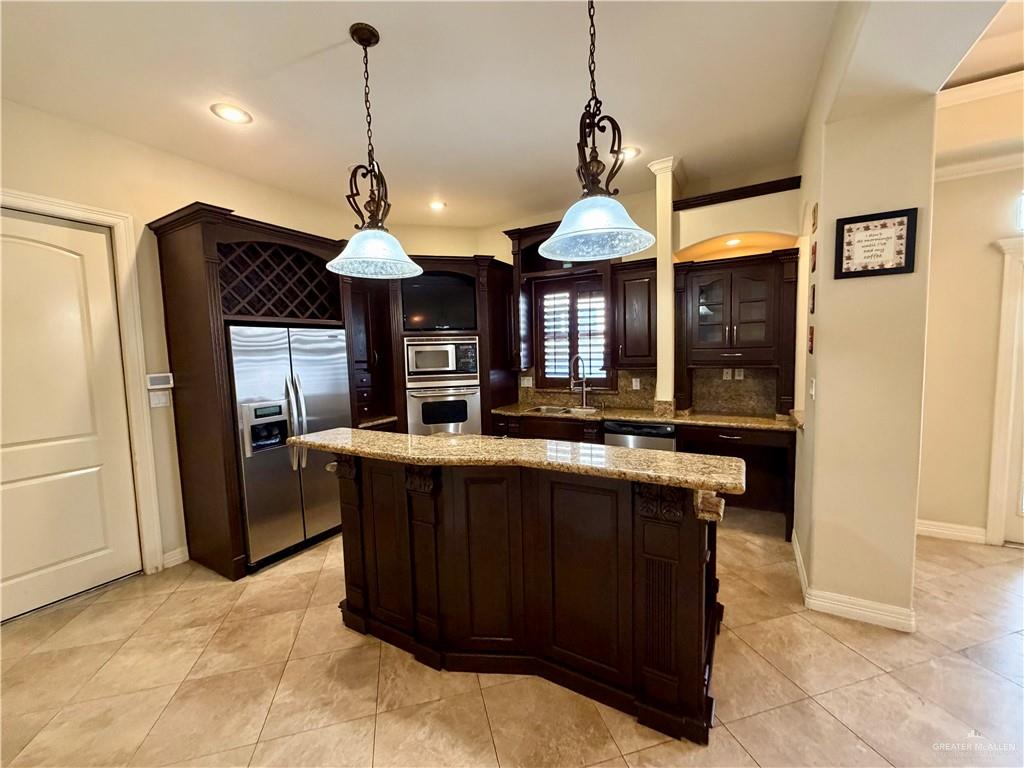 4101 Tyler Avenue McAllen, TX 78503 - Photo 8 of 12 a kitchen with a counter space a sink and refrigerator