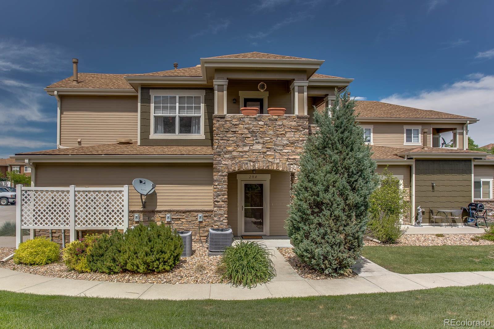6292 Kilmer Loop, Unit 204 Arvada, CO 80403 - Photo 1 of 25 a front view of a house with garden