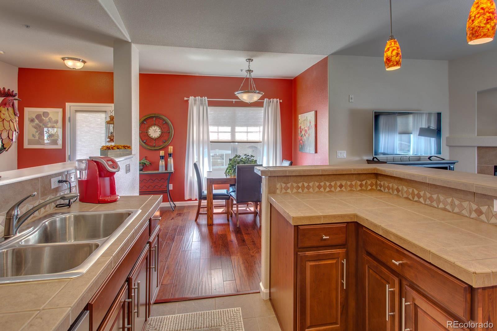 6292 Kilmer Loop, Unit 204 Arvada, CO 80403 - Photo 11 of 25 a kitchen with a sink cabinets and window