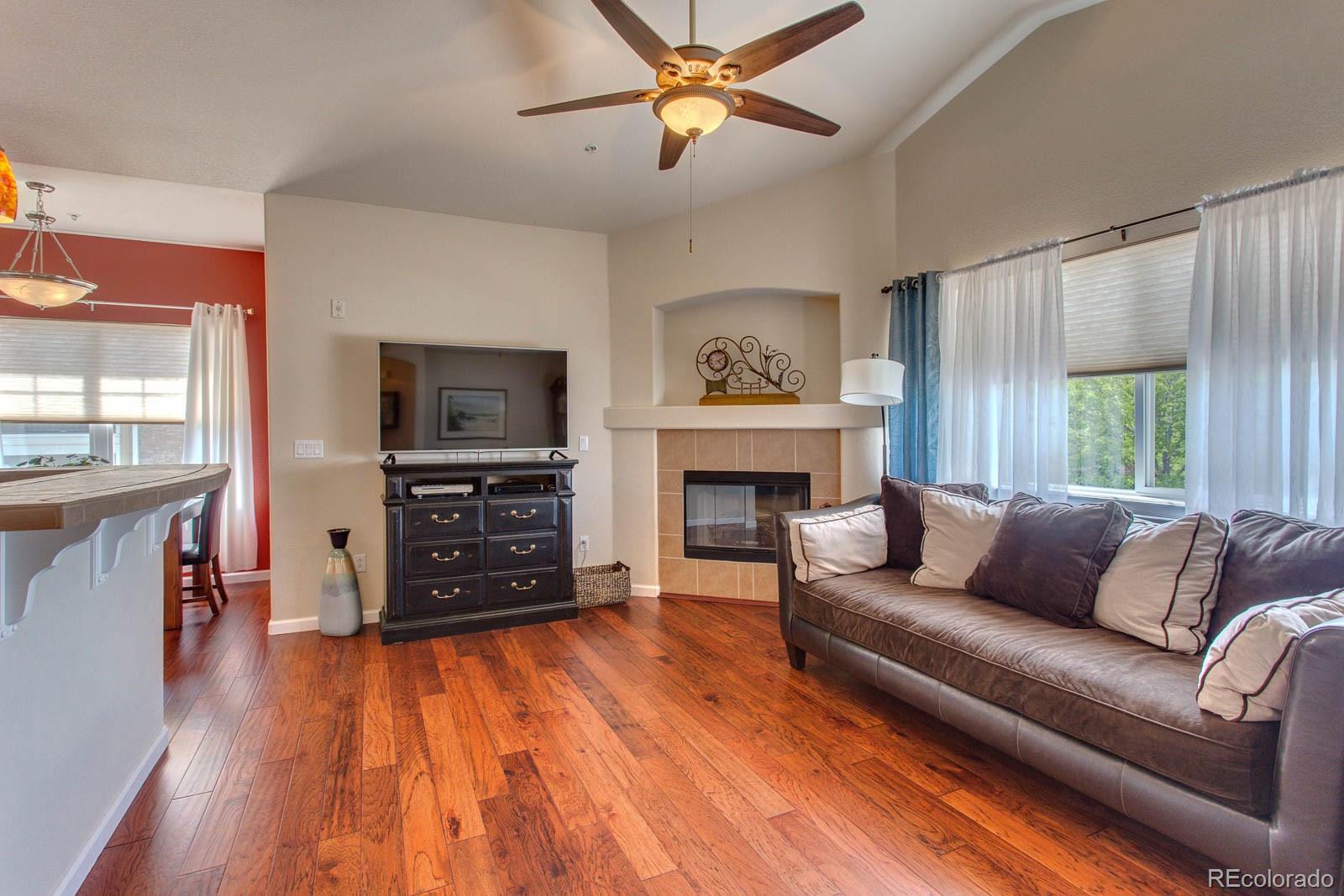6292 Kilmer Loop, Unit 204 Arvada, CO 80403 - Photo 13 of 25 a living room with furniture and a flat screen tv