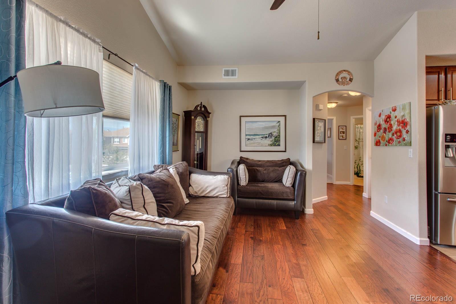 6292 Kilmer Loop, Unit 204 Arvada, CO 80403 - Photo 14 of 25 a living room with furniture and a wooden floor