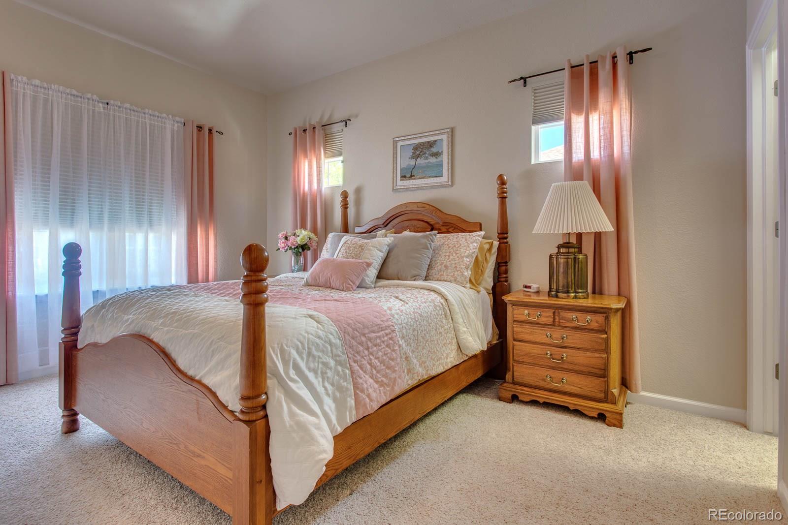 6292 Kilmer Loop, Unit 204 Arvada, CO 80403 - Photo 16 of 25 a spacious bedroom with a bed and window