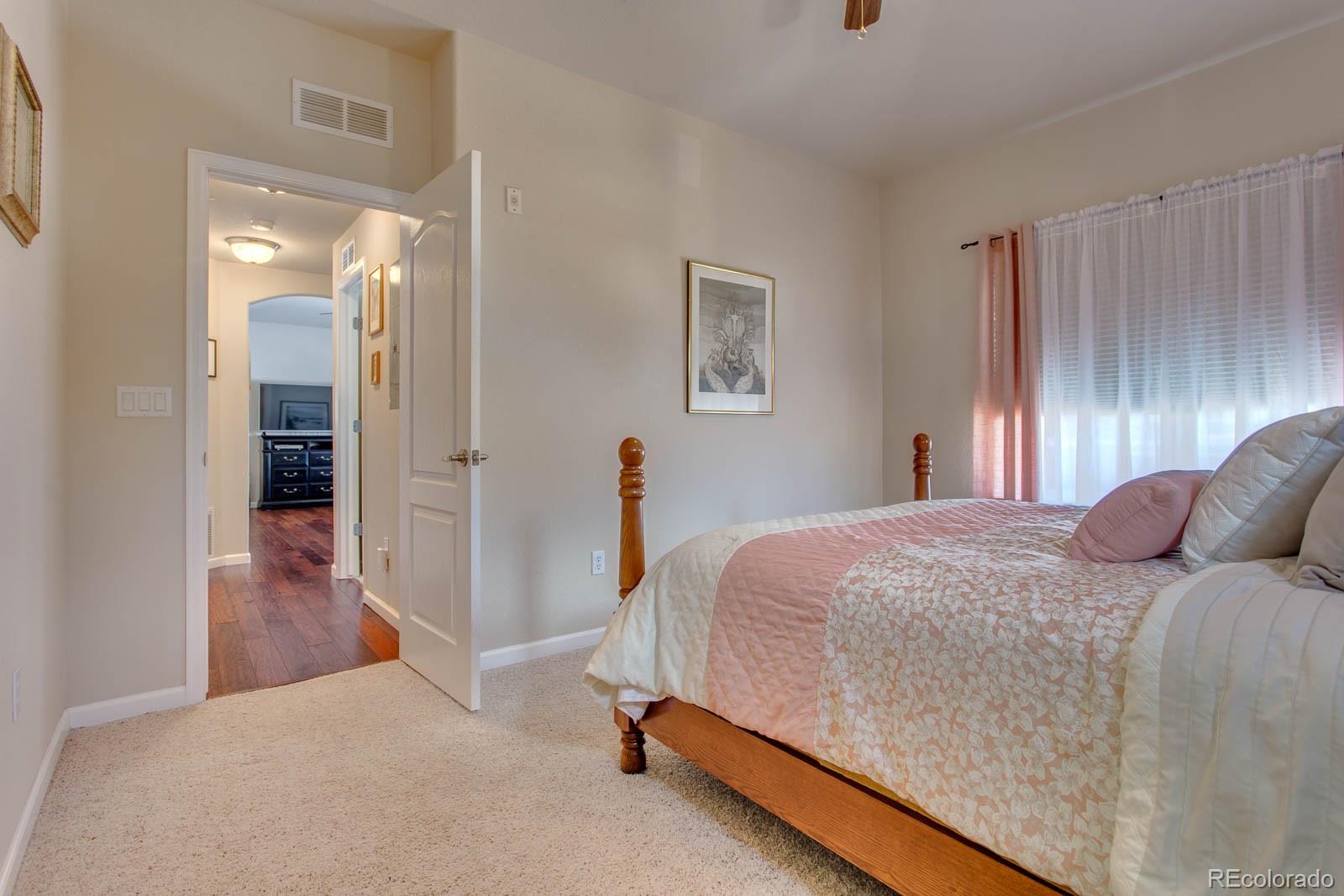 6292 Kilmer Loop, Unit 204 Arvada, CO 80403 - Photo 17 of 25 a bedroom with a bed and a mirror