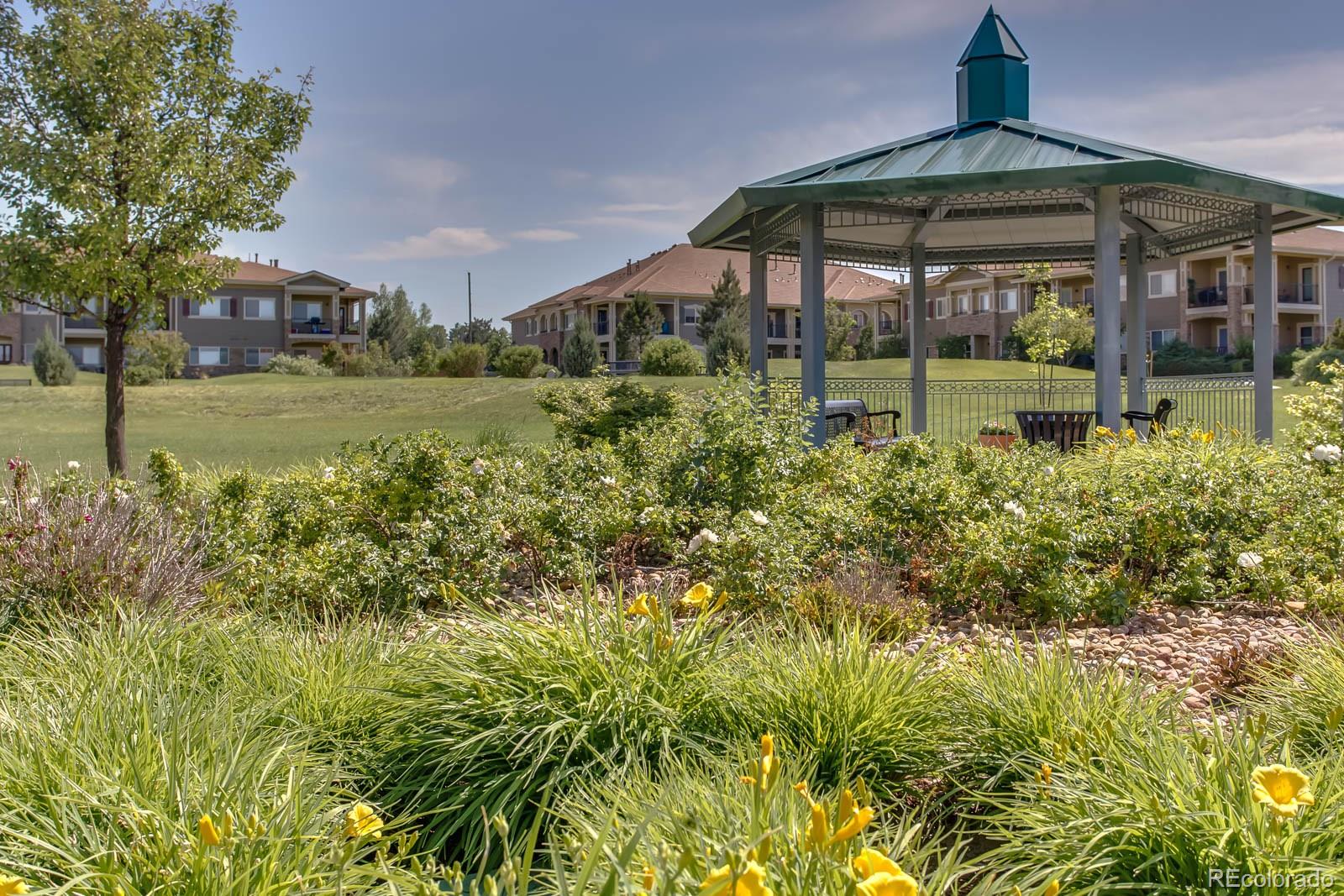 6292 Kilmer Loop, Unit 204 Arvada, CO 80403 - Photo 24 of 25 a front view of a house with a yard