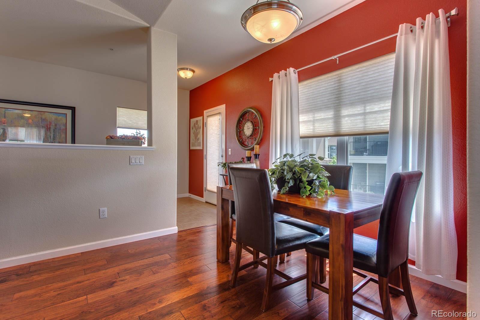 6292 Kilmer Loop, Unit 204 Arvada, CO 80403 - Photo 6 of 25 a view of a dining room with furniture and wooden floor