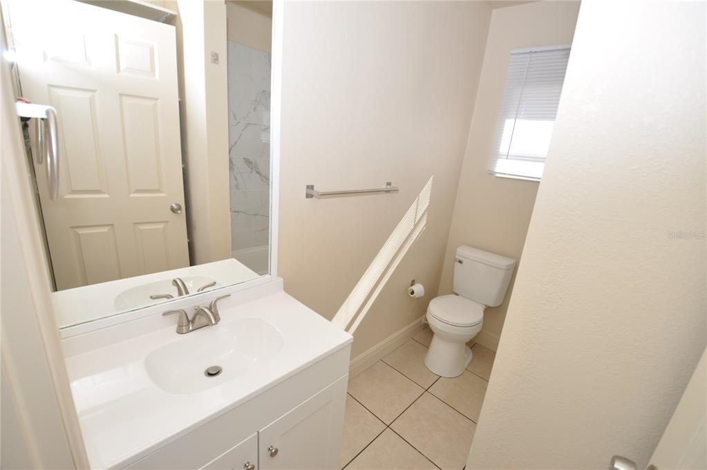 1445 East Stuart Street Bartow, FL 33830 - Photo 12 of 18 a bathroom with a sink a toilet and shower