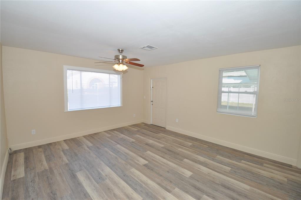 1445 East Stuart Street Bartow, FL 33830 - Photo 7 of 18 wooden floor in an empty room with a window