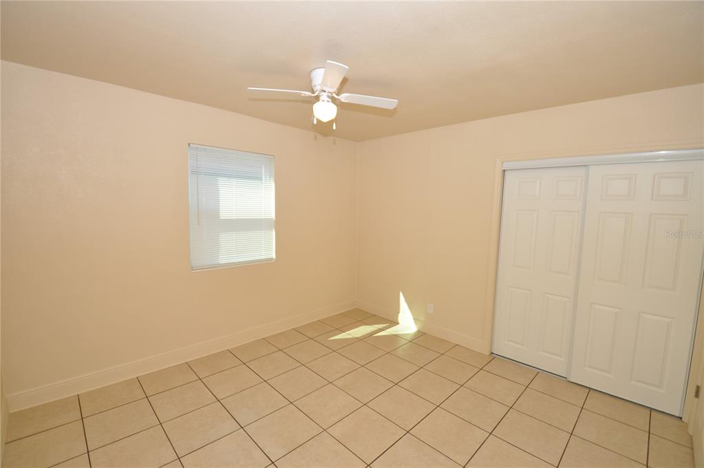 1445 East Stuart Street Bartow, FL 33830 - Photo 10 of 18 a view of a livingroom with an empty space and a ceiling fan