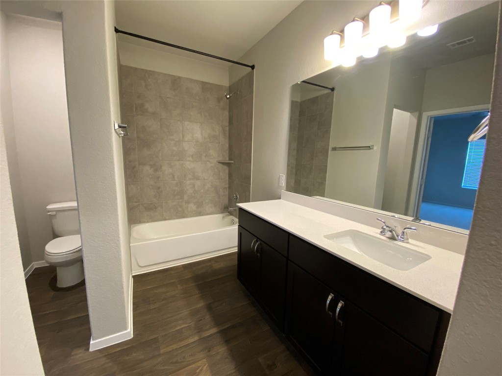 194 Heritage Ml Trail Elgin, TX 78621 - Photo 6 of 25 a bathroom with a sink a toilet and shower