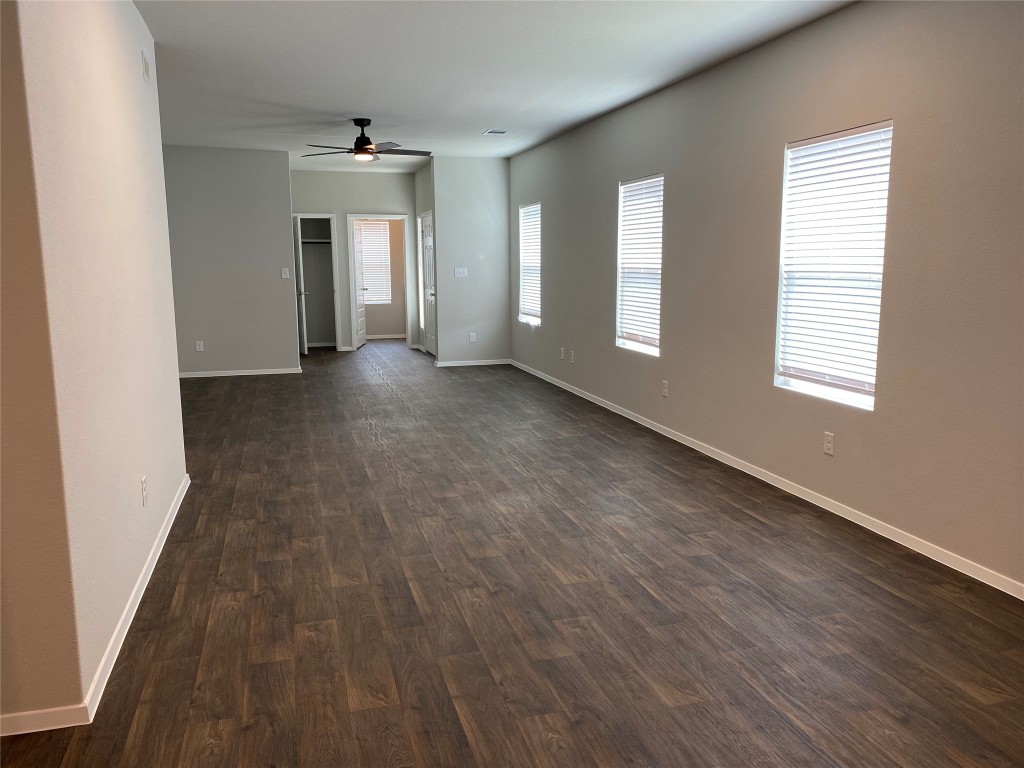 194 Heritage Ml Trail Elgin, TX 78621 - Photo 10 of 25 an empty room with wooden floor and windows