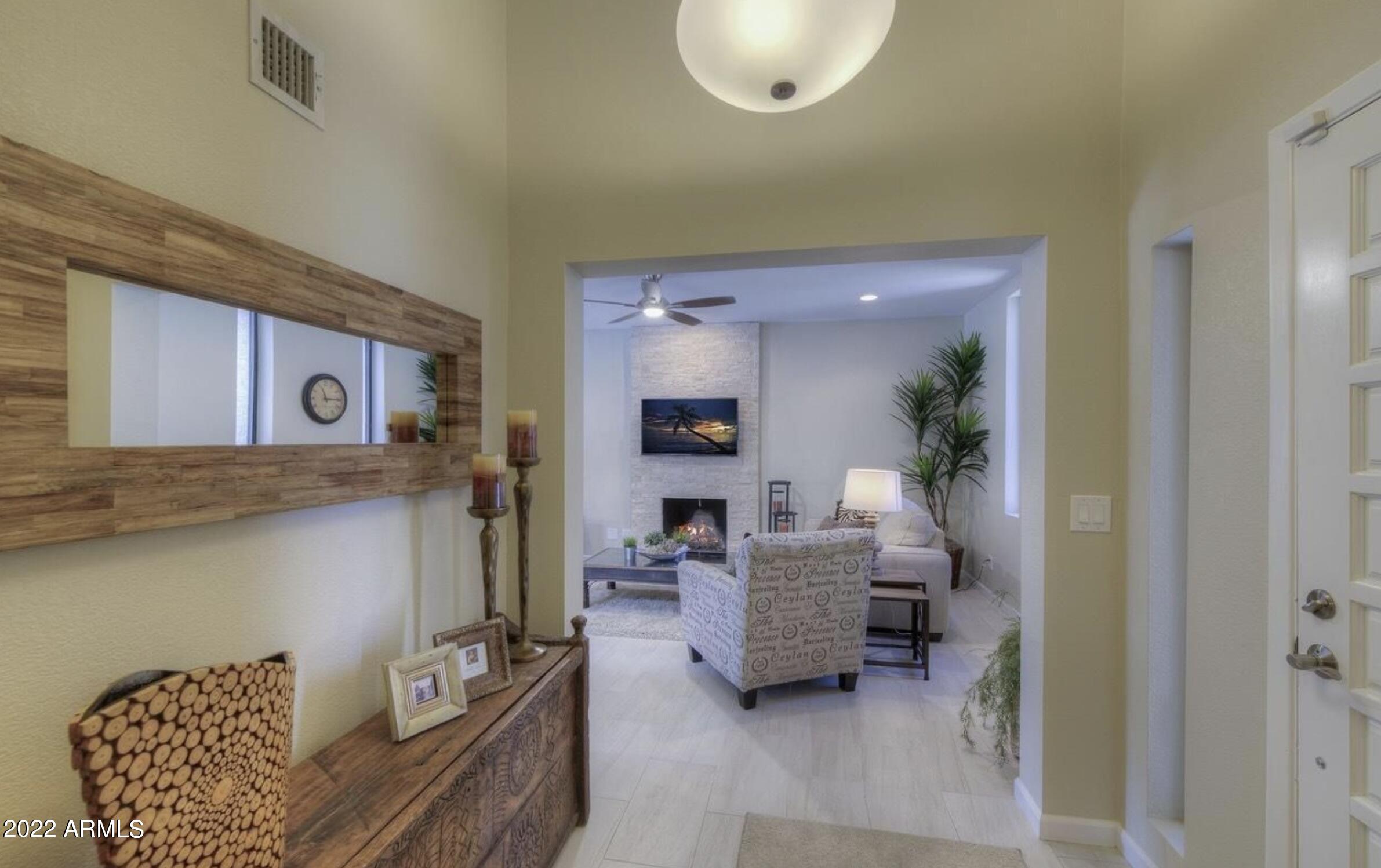 6609 East Phelps Road Scottsdale, AZ 85254 - Photo 51 of 83 a living room with furniture and a chandelier