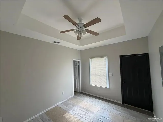 a view of a livingroom with a ceiling fan and window