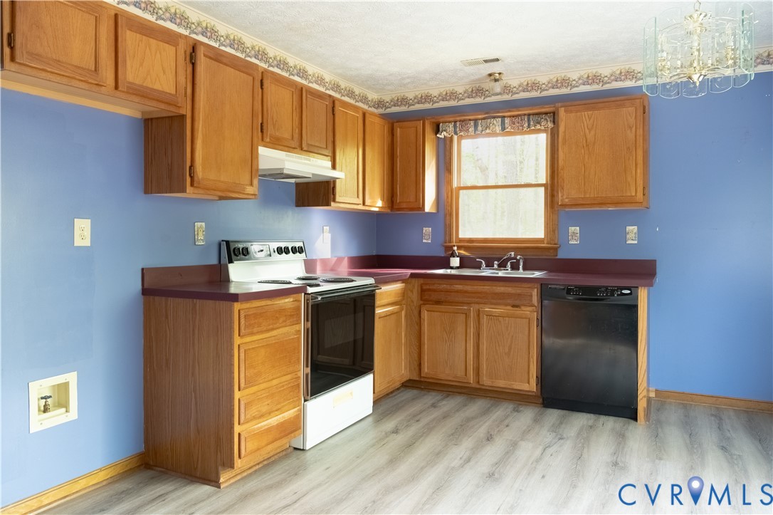 2477 Calno Road Hanover, VA 23069 - Photo 8 of 33 a kitchen with stainless steel appliances granite countertop a stove a sink and a microwave