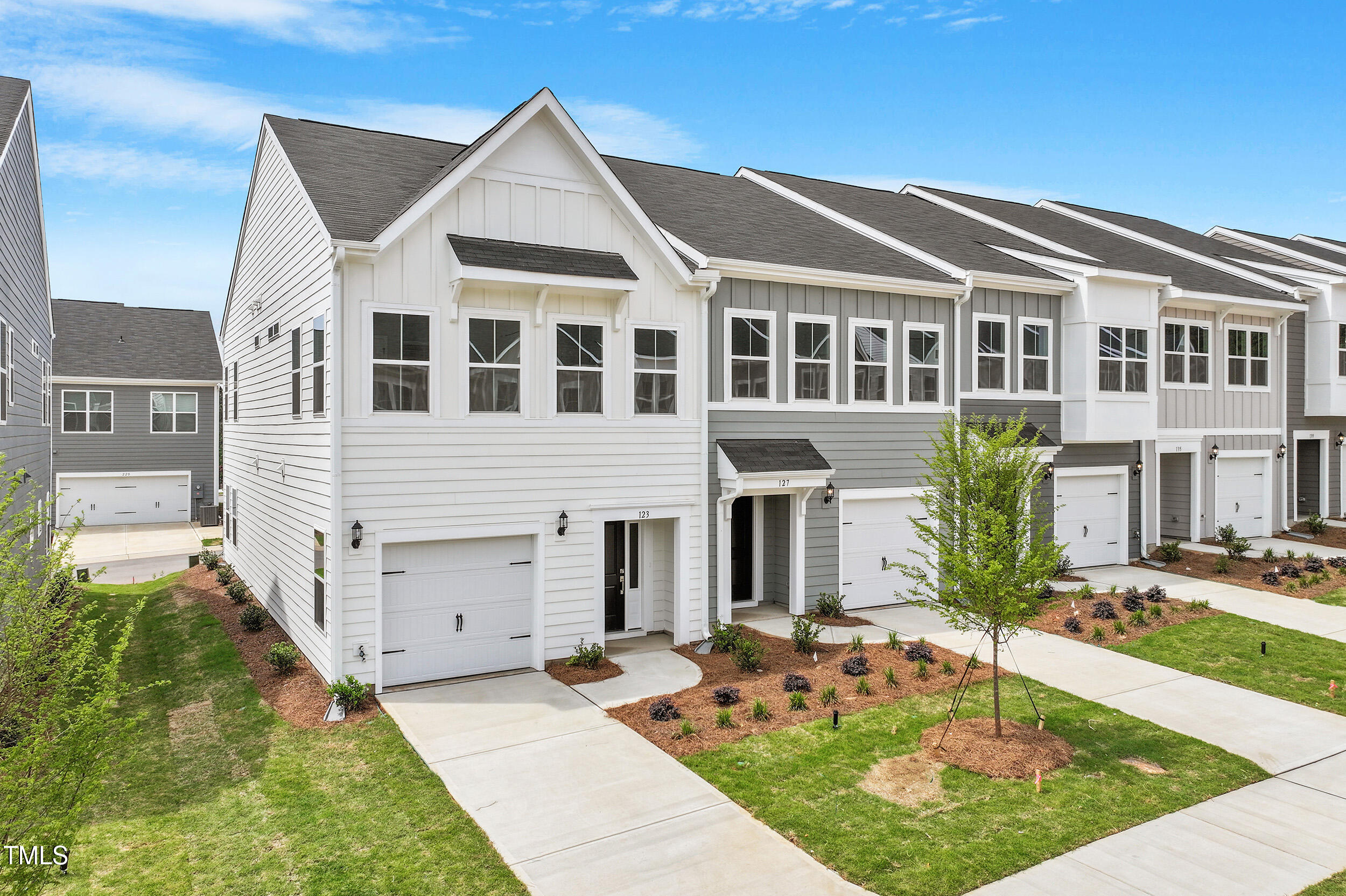 123 Powell Townes Way, Unit 302 Raleigh, NC 27603 - Photo 1 of 44 a front view of a house with a yard