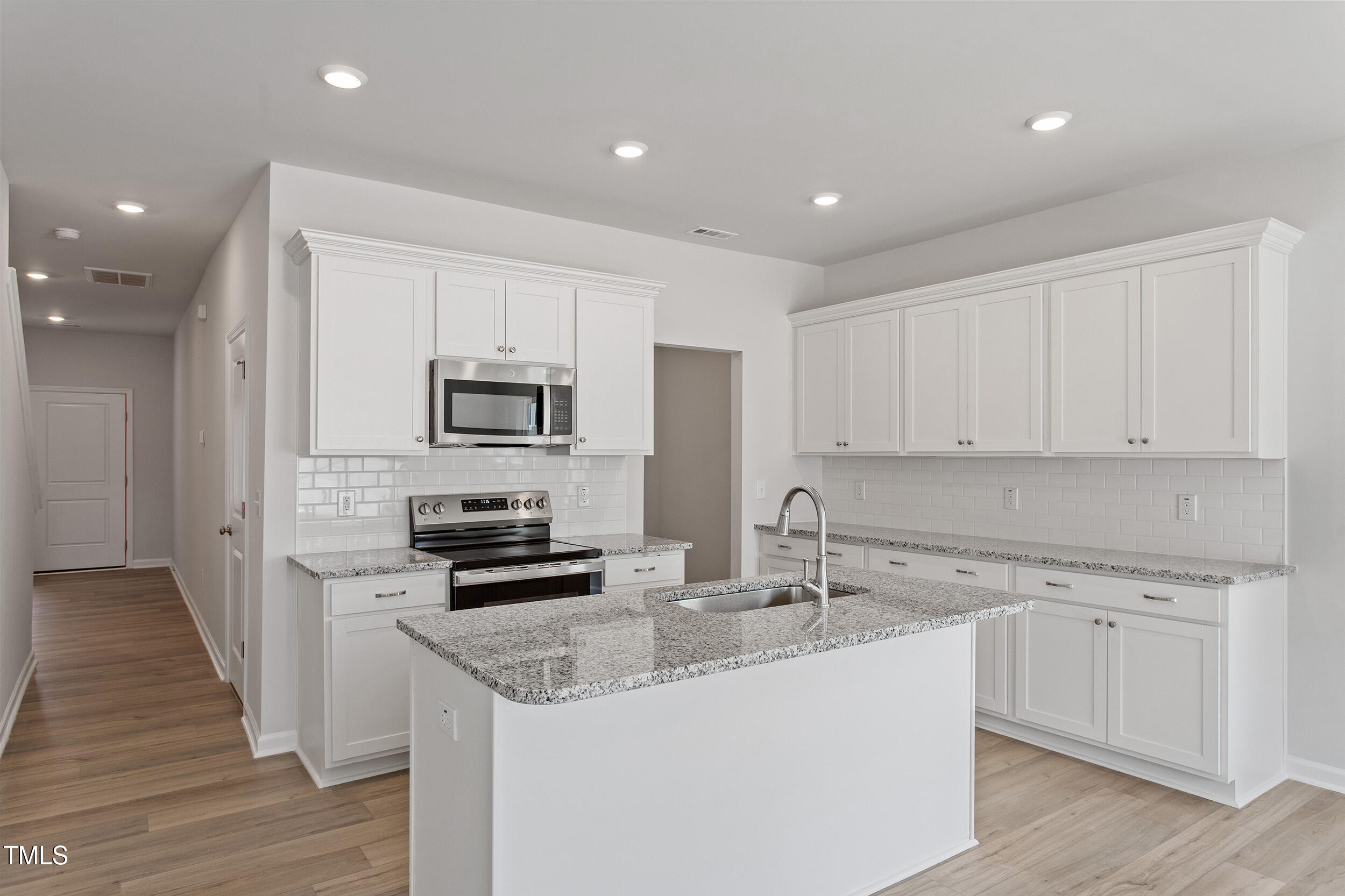 123 Powell Townes Way, Unit 302 Raleigh, NC 27603 - Photo 12 of 44 a kitchen with stainless steel appliances granite countertop a sink and cabinets