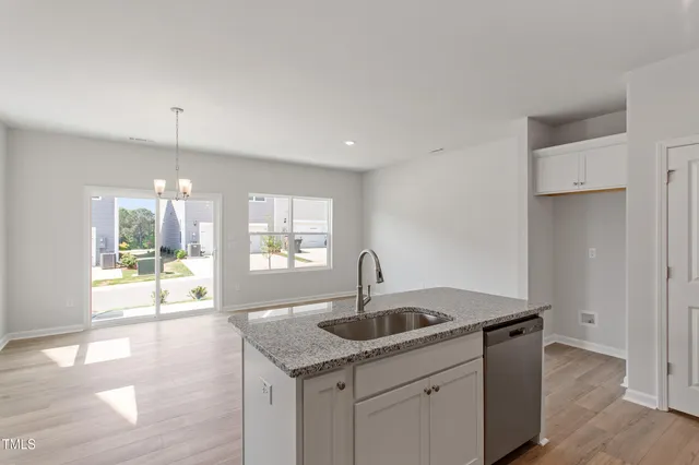 a kitchen with a sink and chandelier