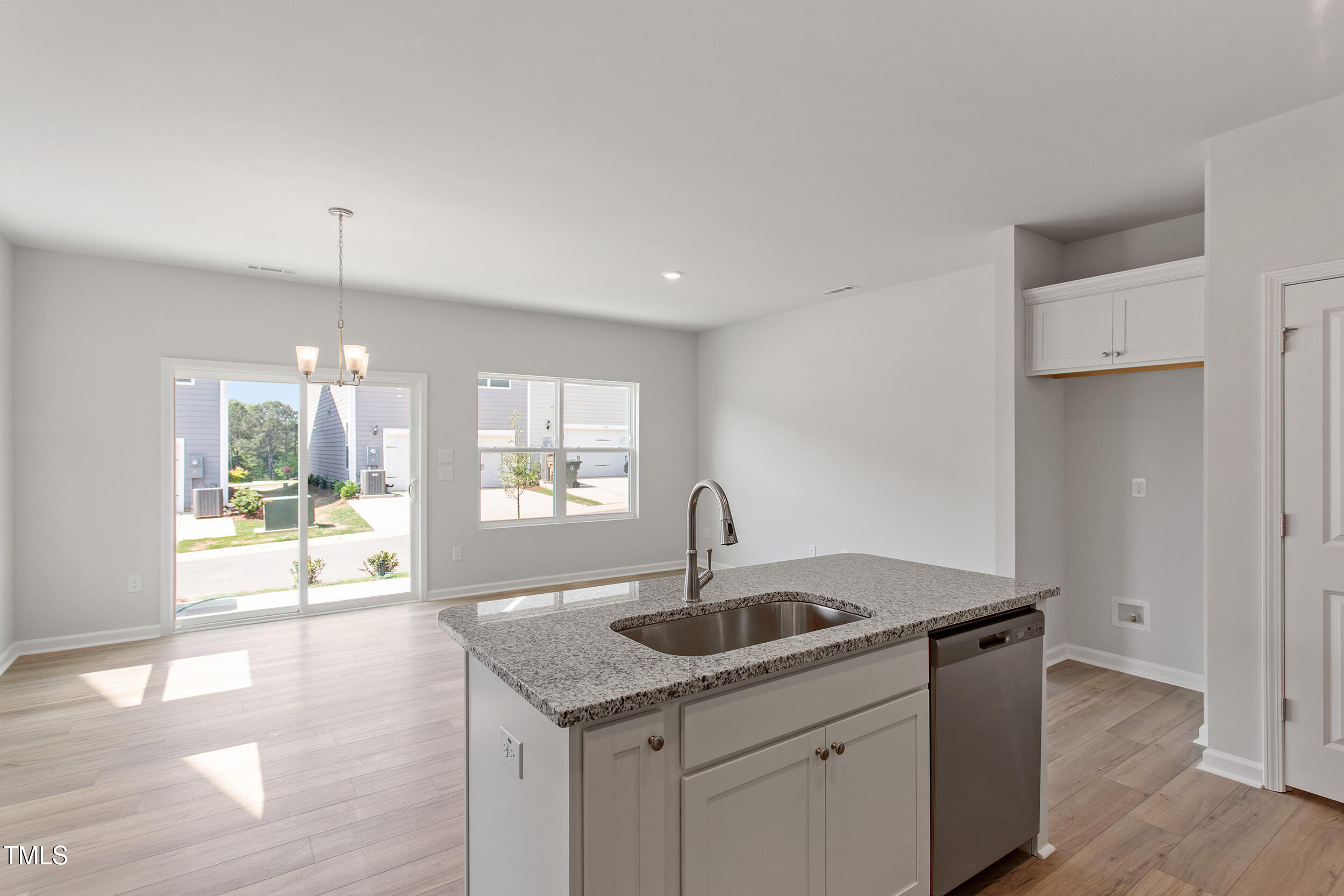 123 Powell Townes Way, Unit 302 Raleigh, NC 27603 - Photo 16 of 44 a kitchen with a sink and chandelier