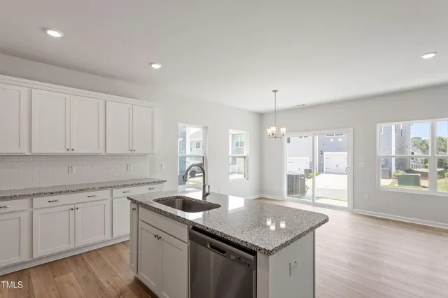 a kitchen with a sink stove and cabinets