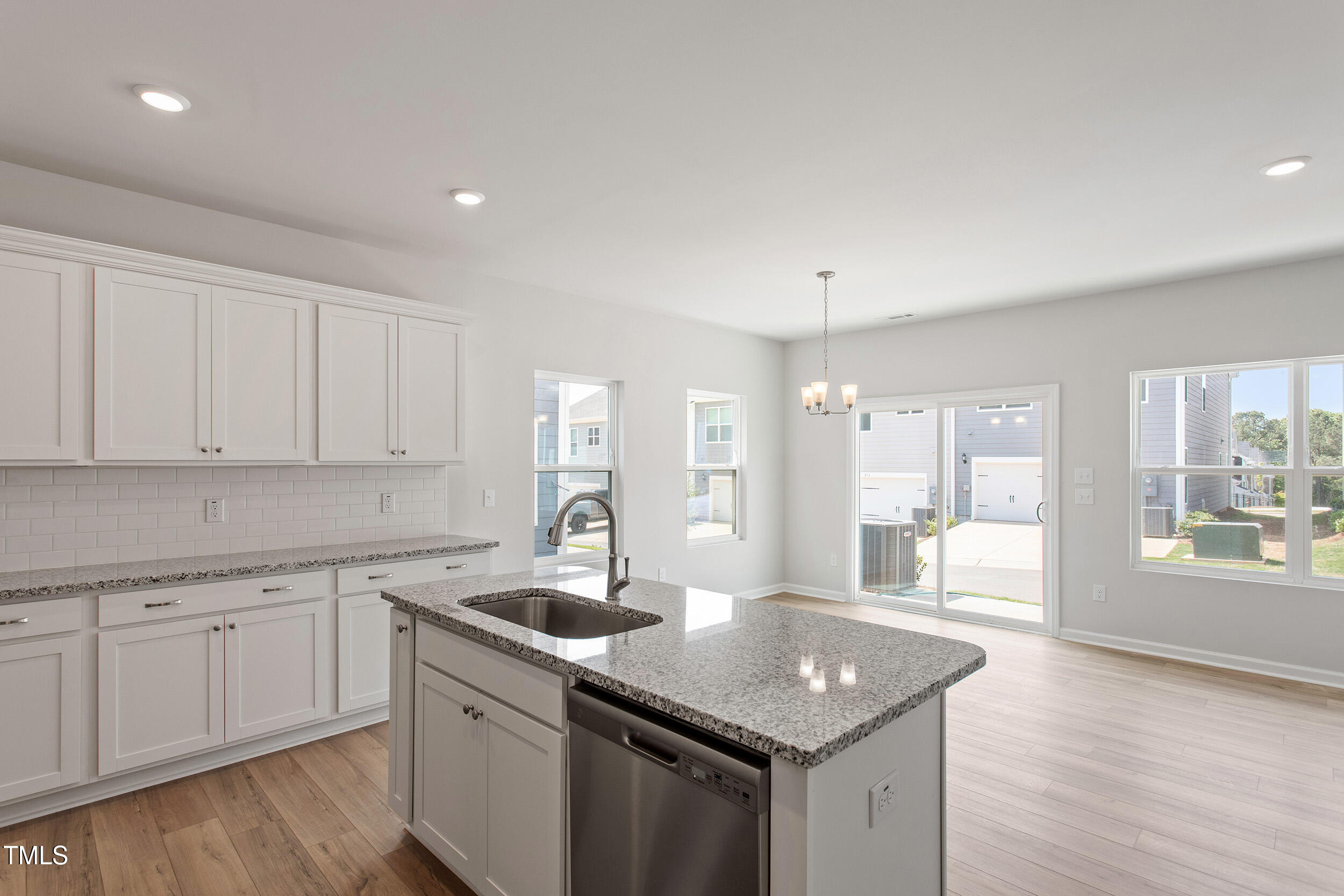 123 Powell Townes Way, Unit 302 Raleigh, NC 27603 - Photo 17 of 44 a kitchen with a sink stove and cabinets