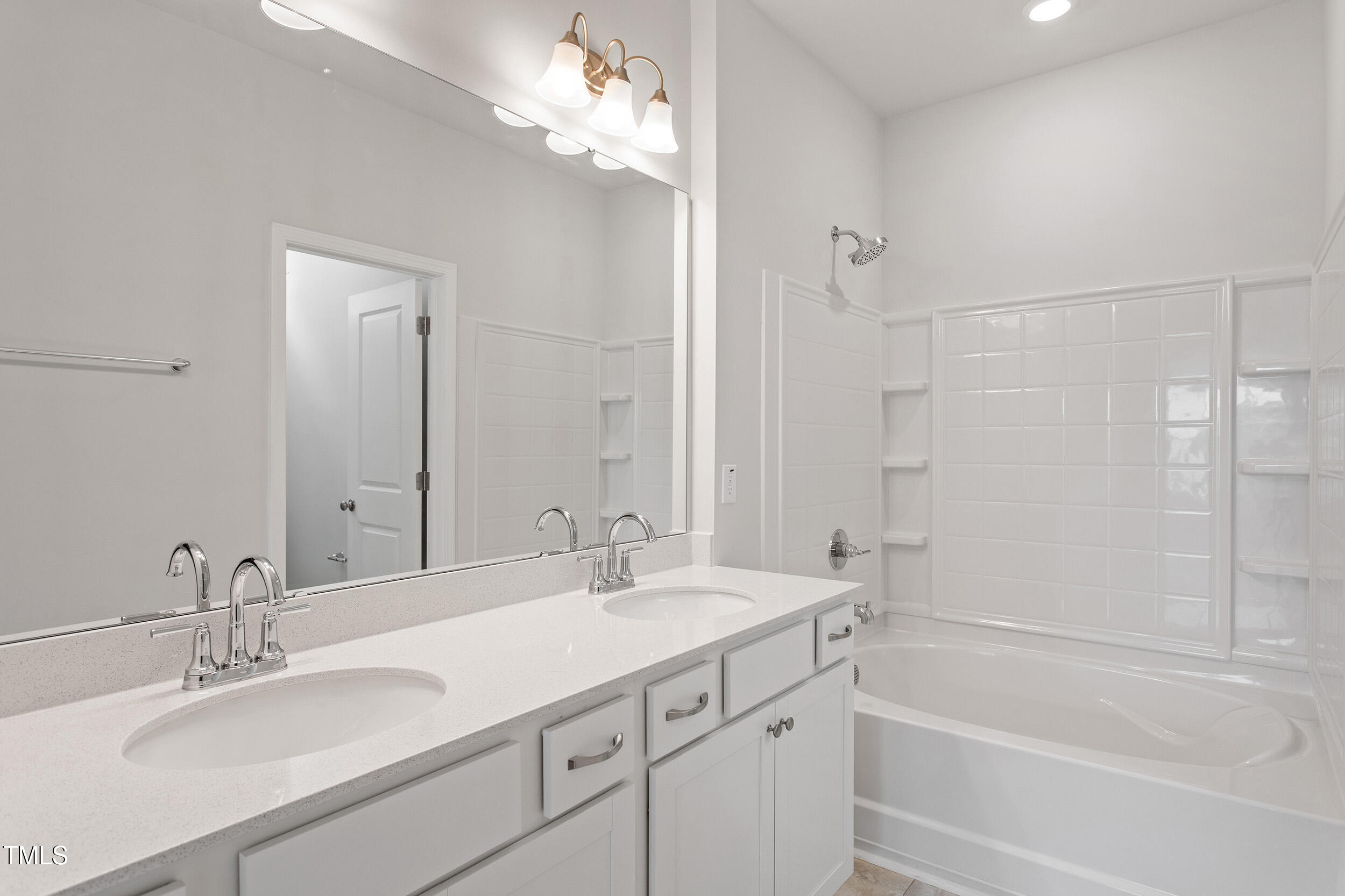 123 Powell Townes Way, Unit 302 Raleigh, NC 27603 - Photo 23 of 44 a bathroom with a tub sink double vanity and shower