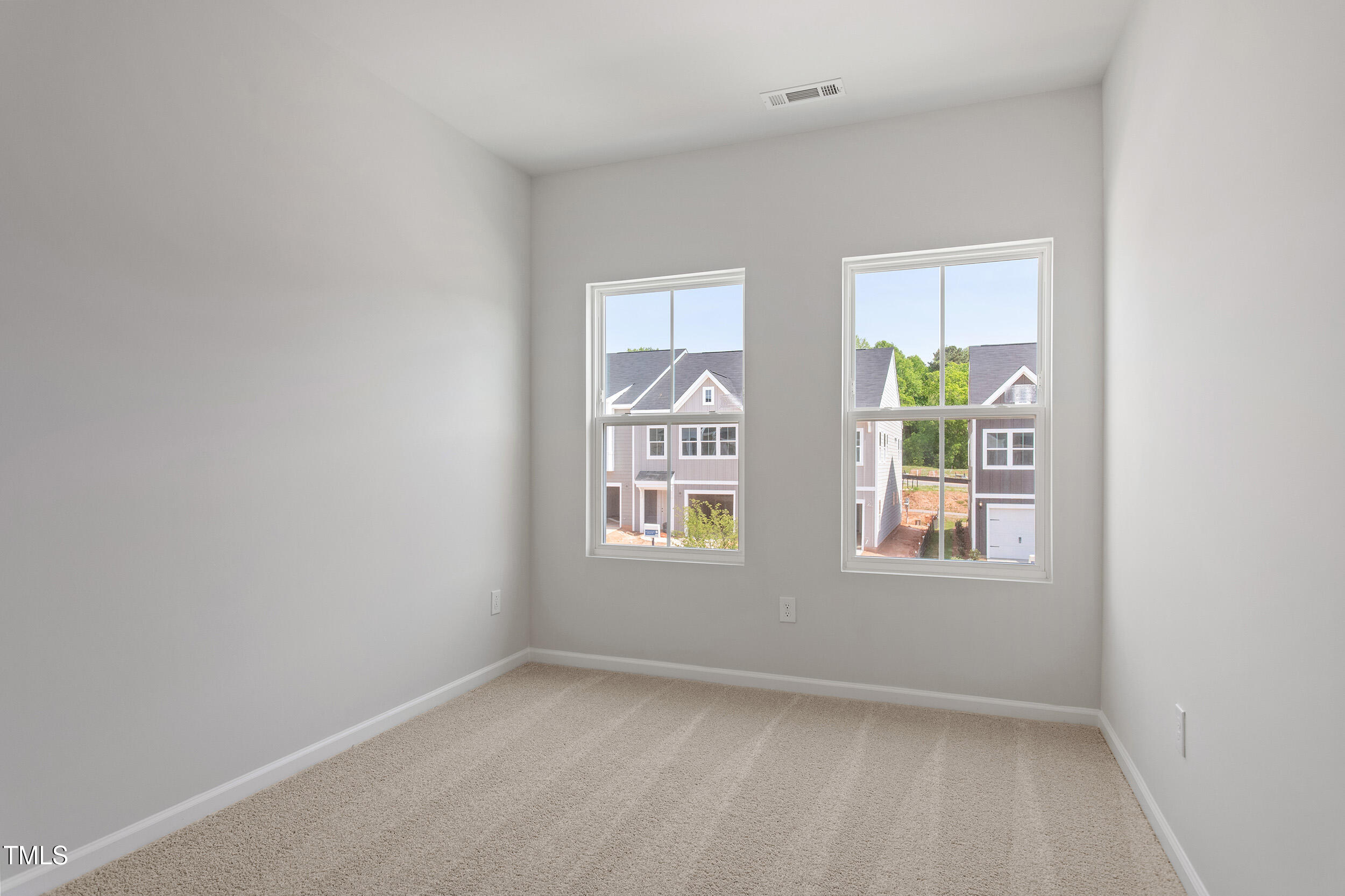 123 Powell Townes Way, Unit 302 Raleigh, NC 27603 - Photo 24 of 44 an empty room with windows