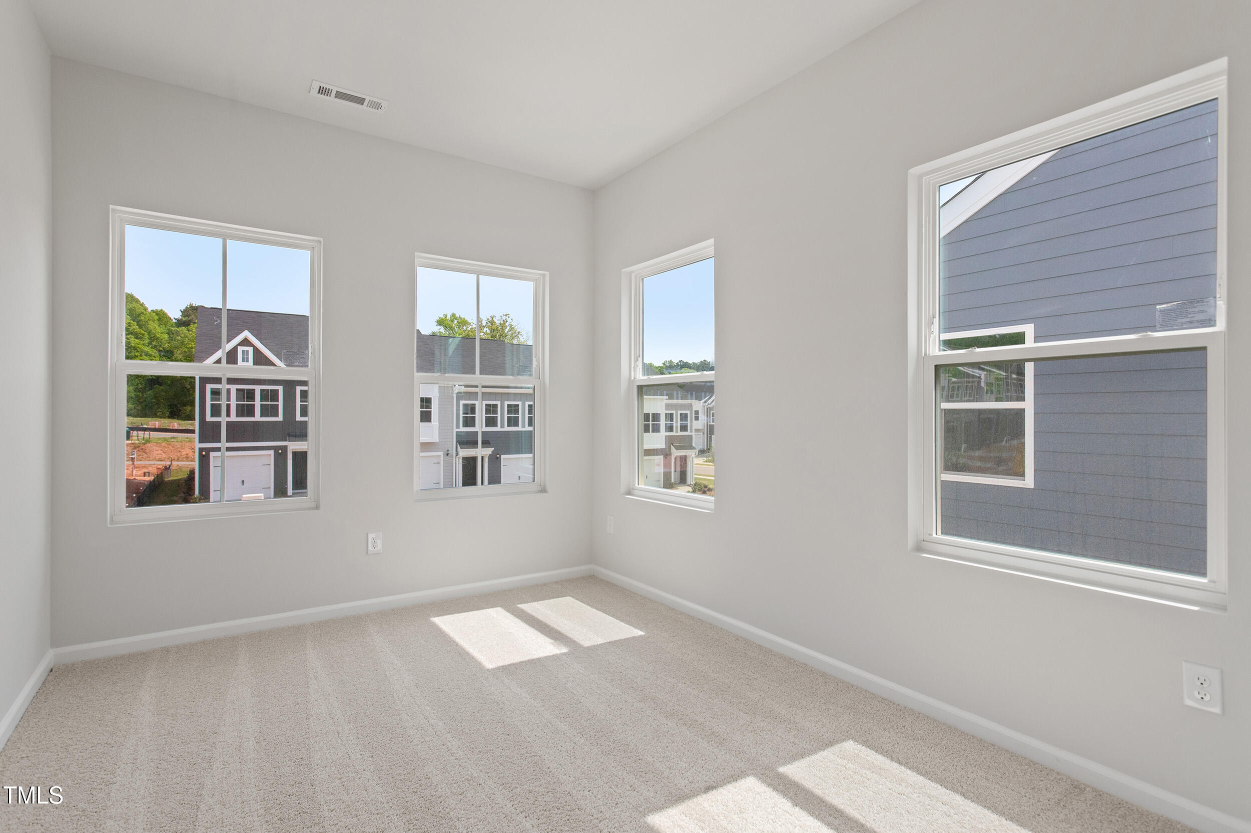 123 Powell Townes Way, Unit 302 Raleigh, NC 27603 - Photo 25 of 44 a view of empty room with windows