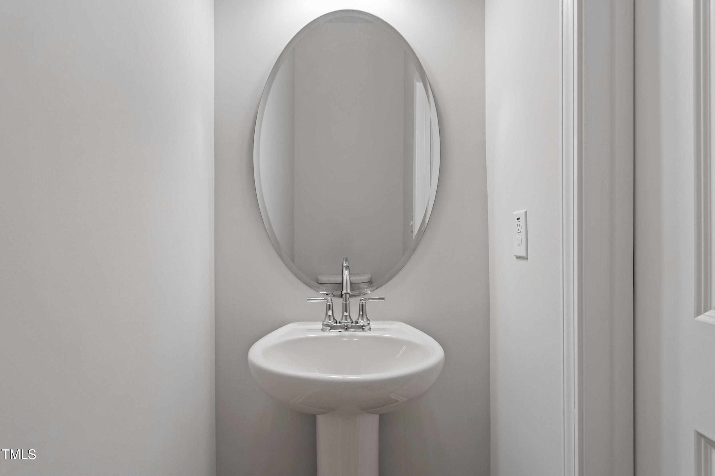 123 Powell Townes Way, Unit 302 Raleigh, NC 27603 - Photo 28 of 44 a bathroom with a sink and a mirror