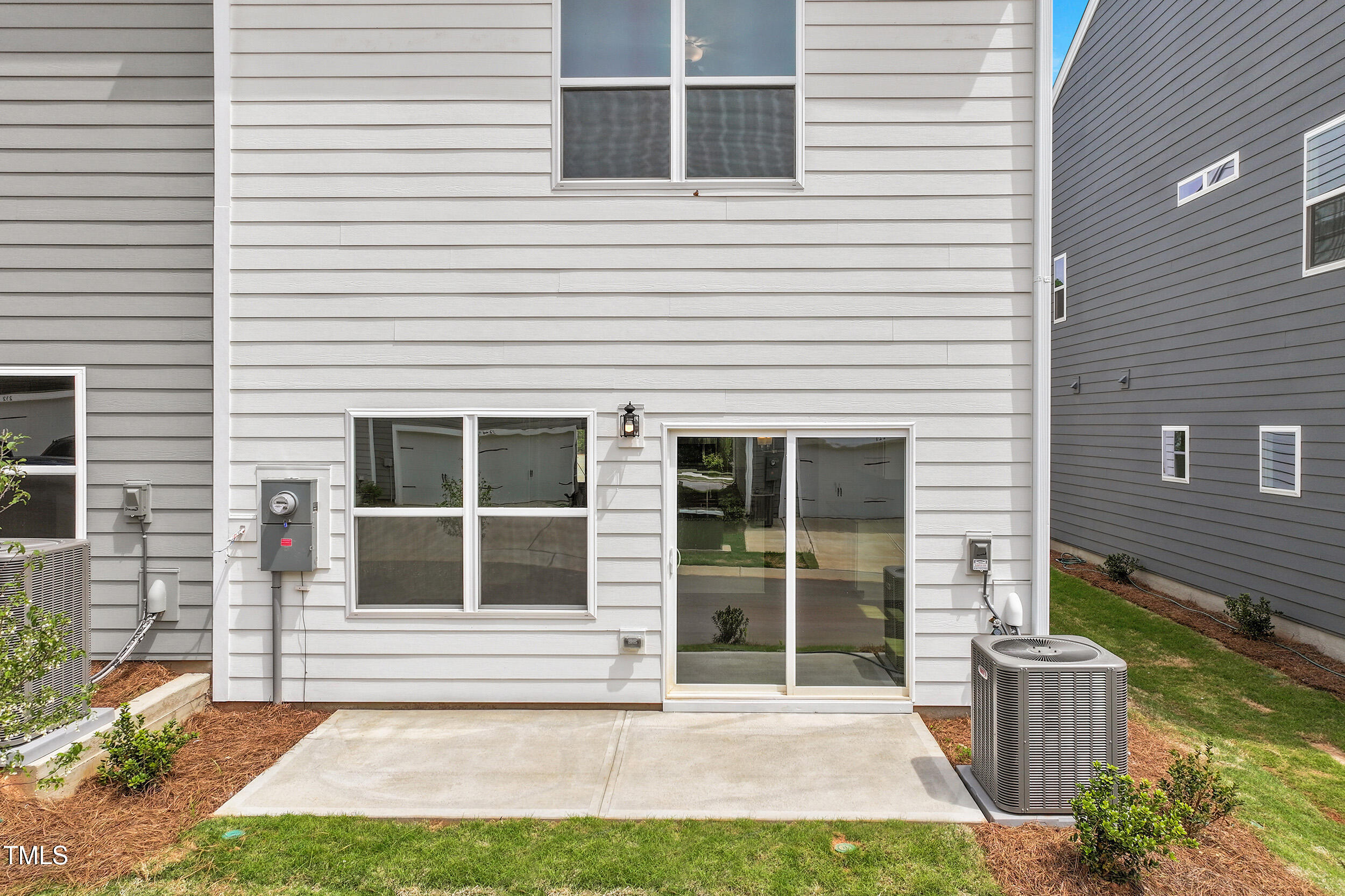 123 Powell Townes Way, Unit 302 Raleigh, NC 27603 - Photo 29 of 44 a front view of a house with a yard and potted plants