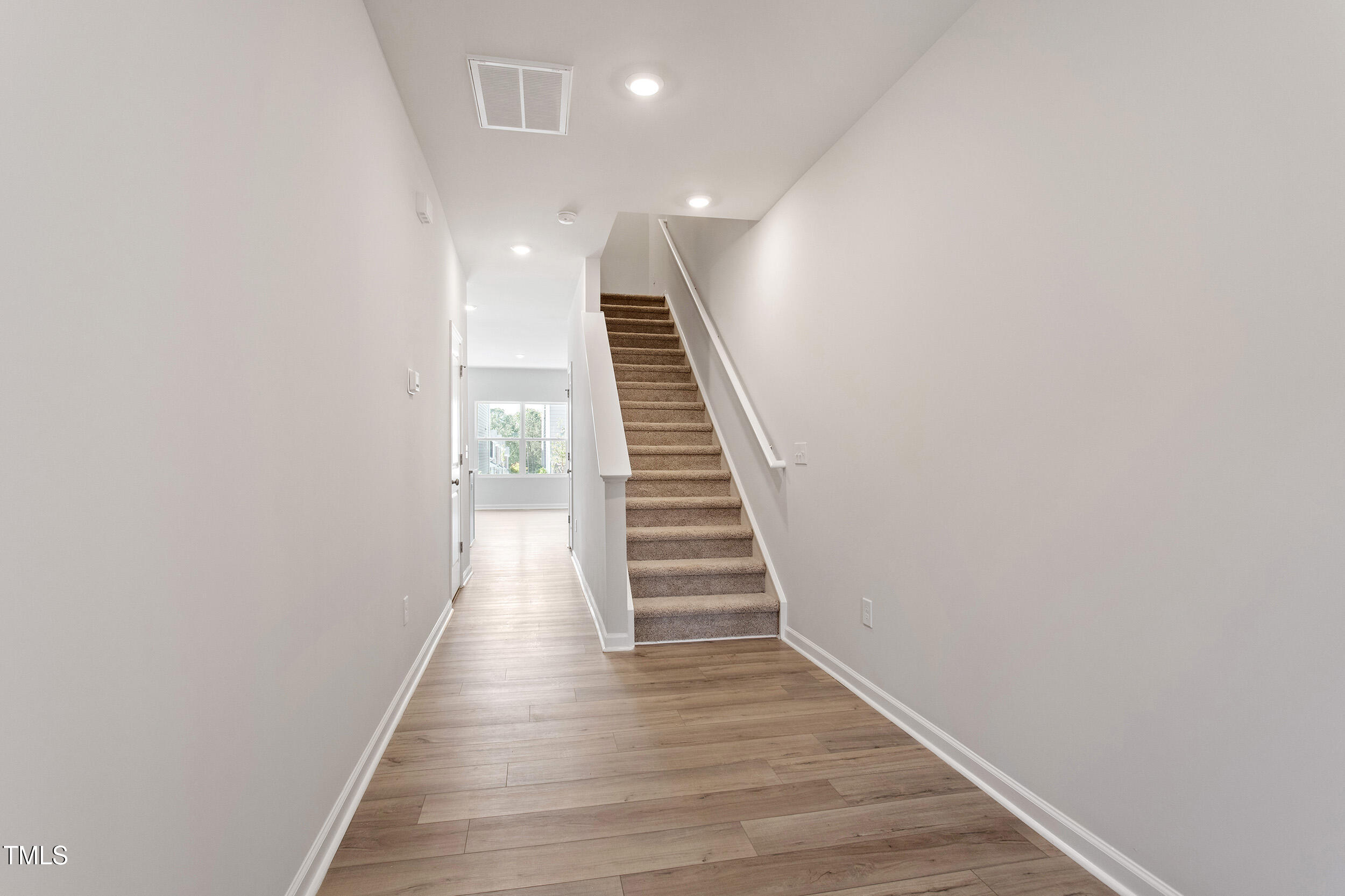 123 Powell Townes Way, Unit 302 Raleigh, NC 27603 - Photo 4 of 44 a view of a hallway with wooden floor