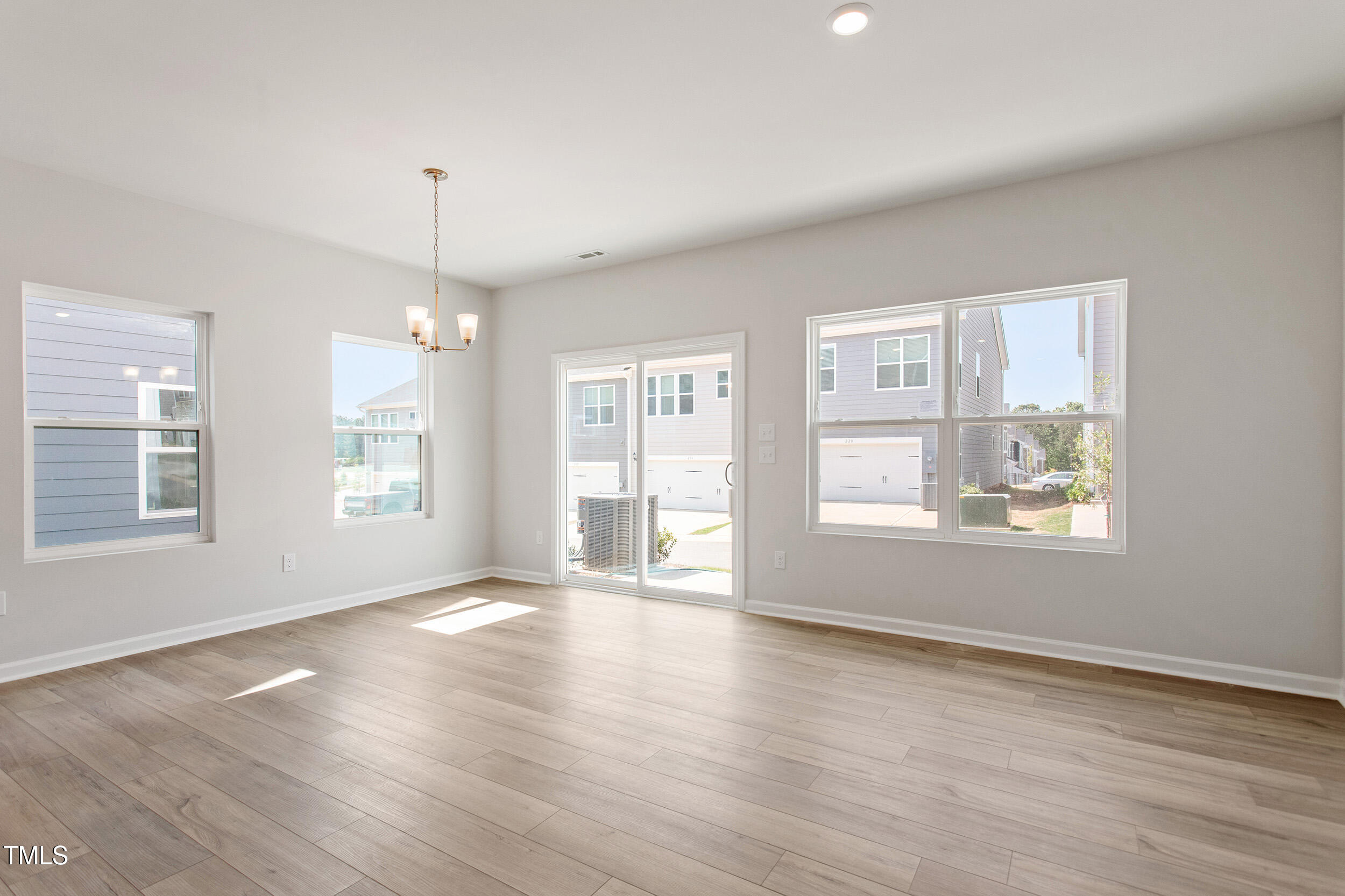 123 Powell Townes Way, Unit 302 Raleigh, NC 27603 - Photo 7 of 44 a view of an empty room with wooden floor and a window
