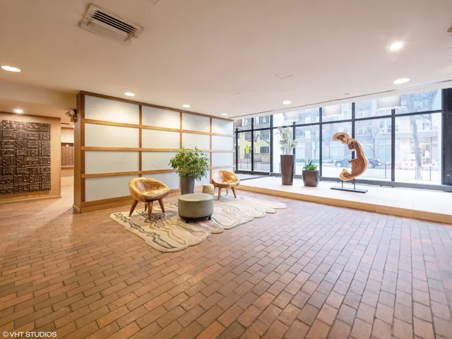 a living room with furniture and a floor to ceiling window