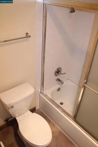 a bathroom with a toilet and a tub