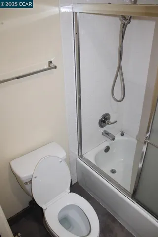 a bathroom with a toilet and a shower