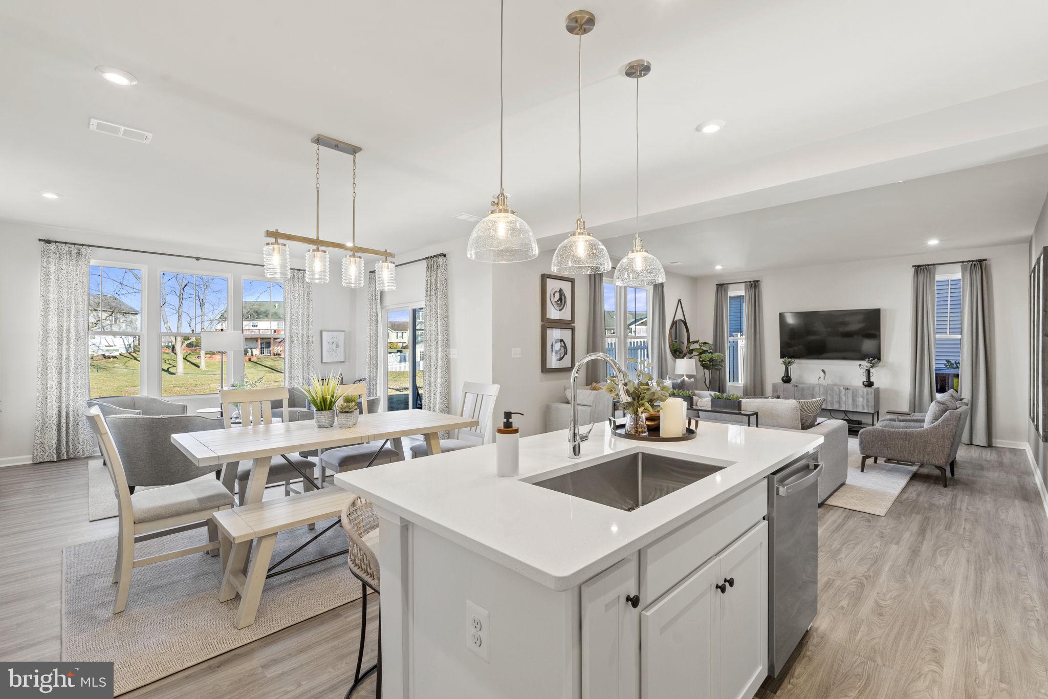 19 Taft Avenue Ranson, WV 25438 - Photo 14 of 50 a kitchen with center island table and chairs in it