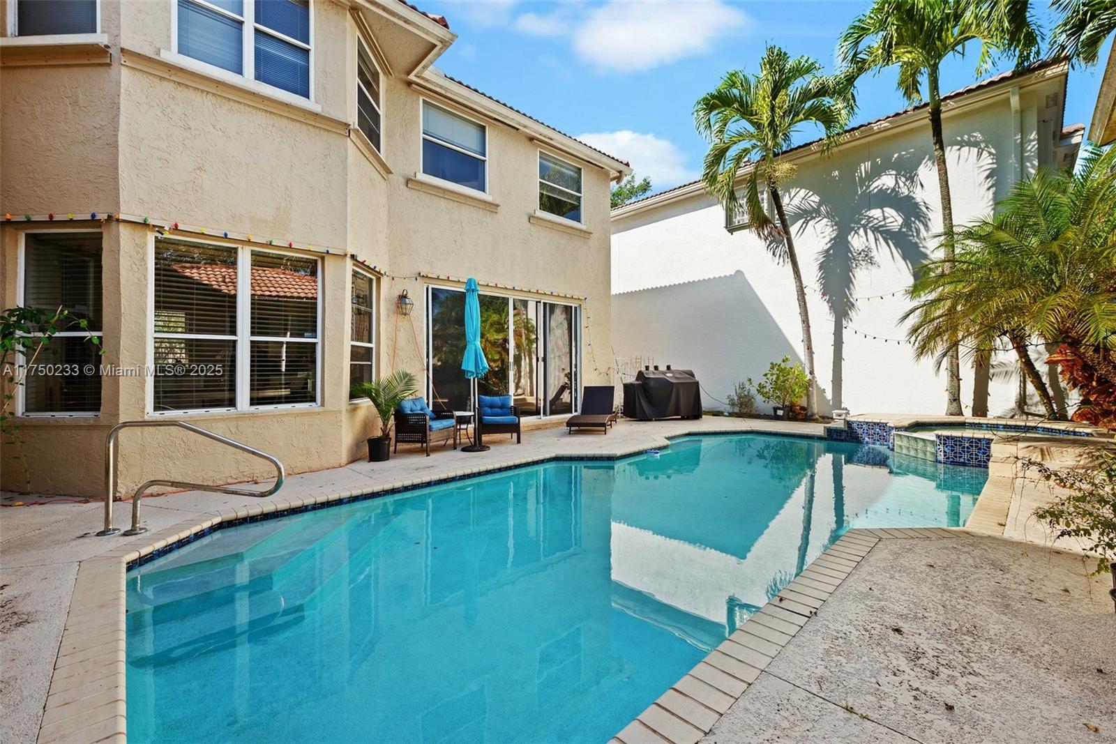 Mission Bay Boca Raton, FL 33498 - Photo 4 of 13 a view of a house with pool and sitting area