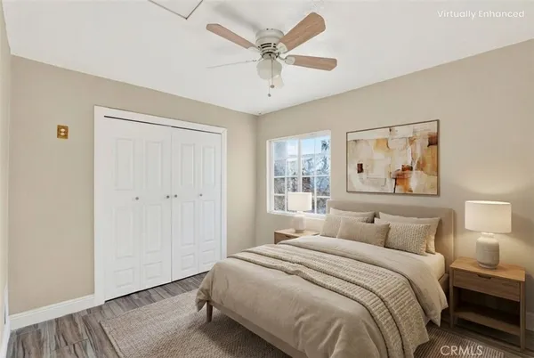 a bedroom with a large bed and a chandelier