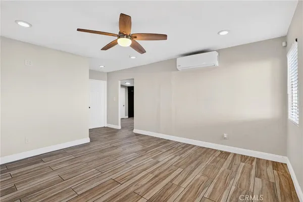 wooden floor in an empty room with a window