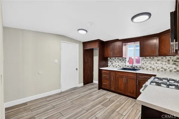 a kitchen with stainless steel appliances granite countertop a sink stove and cabinets