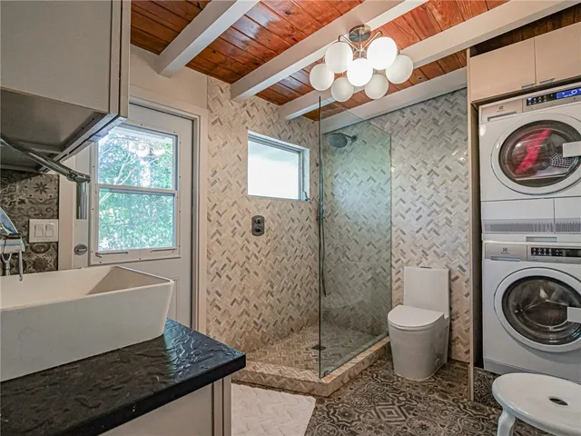 a bathroom with a sink a toilet and a shower