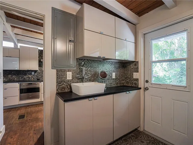 a kitchen with stainless steel appliances granite countertop a sink and a stove