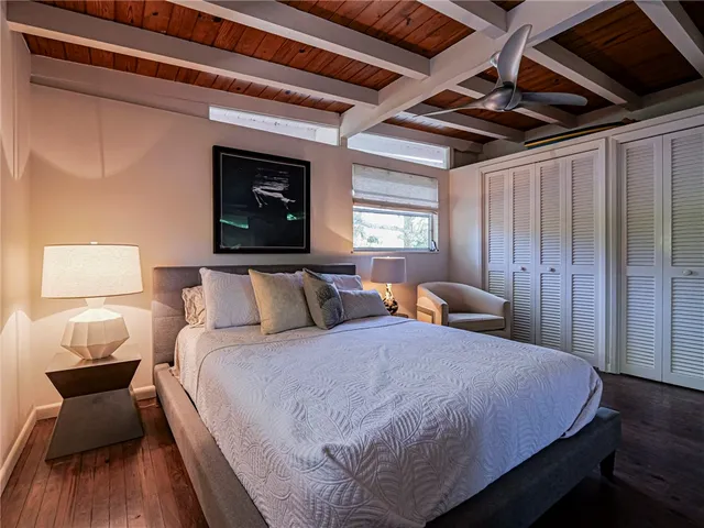 a bed room with a bed and a chair