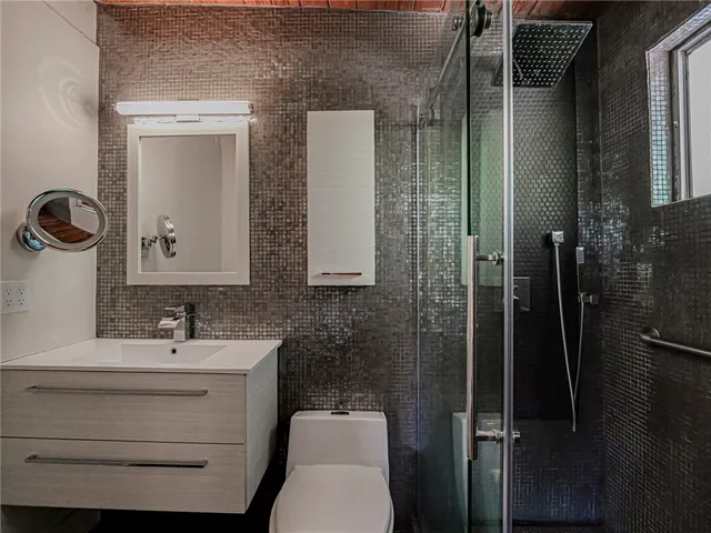 a bathroom with a toilet sink and shower